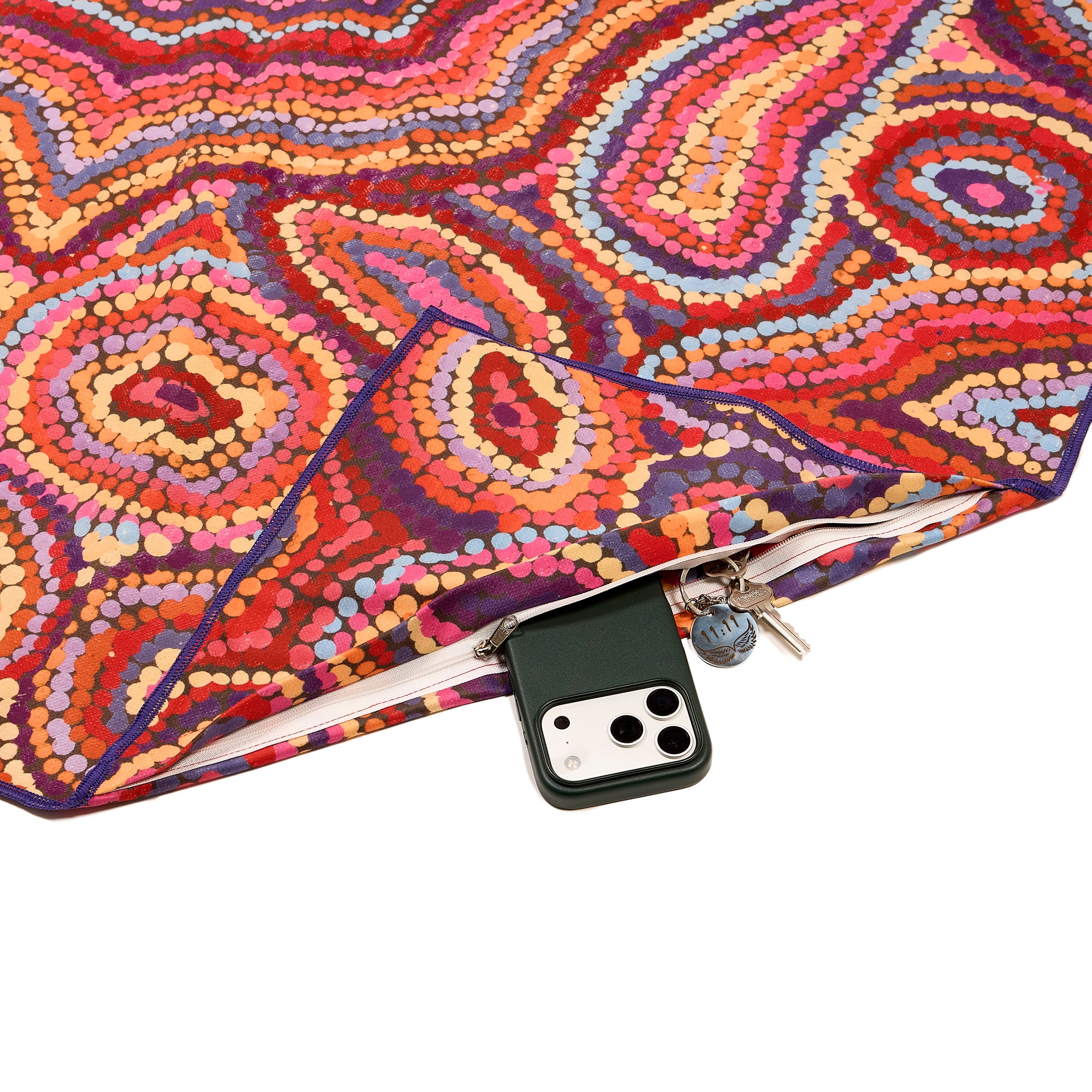 Colorful patterned towel with a phone pocket inside on a white background