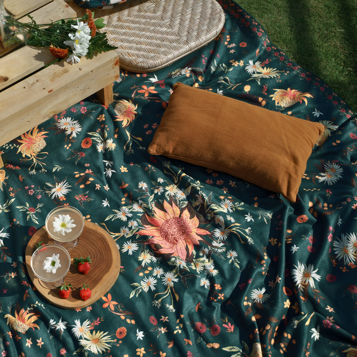 Floral-patterned towel with a picnic spread