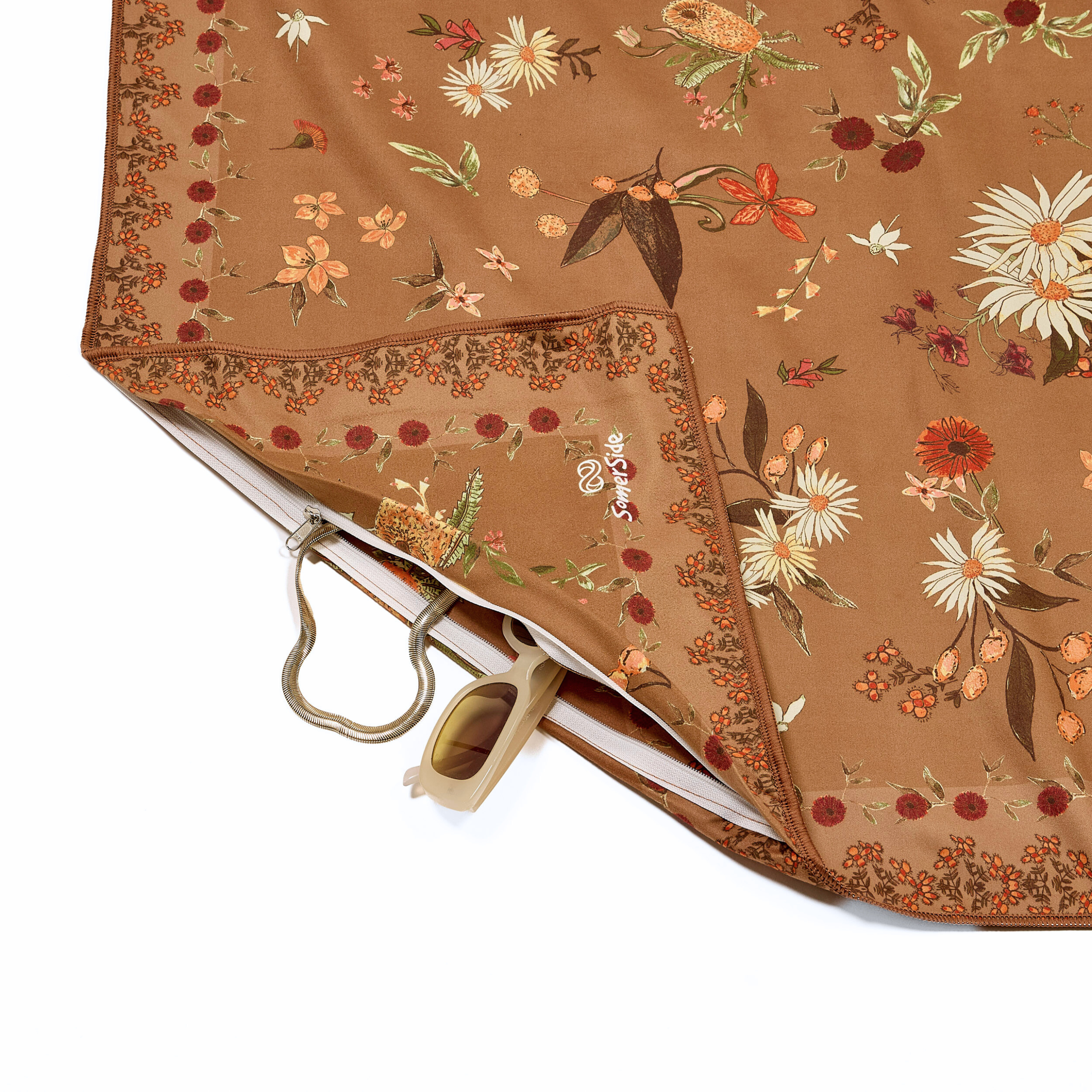 Floral-patterned towel with a brown background