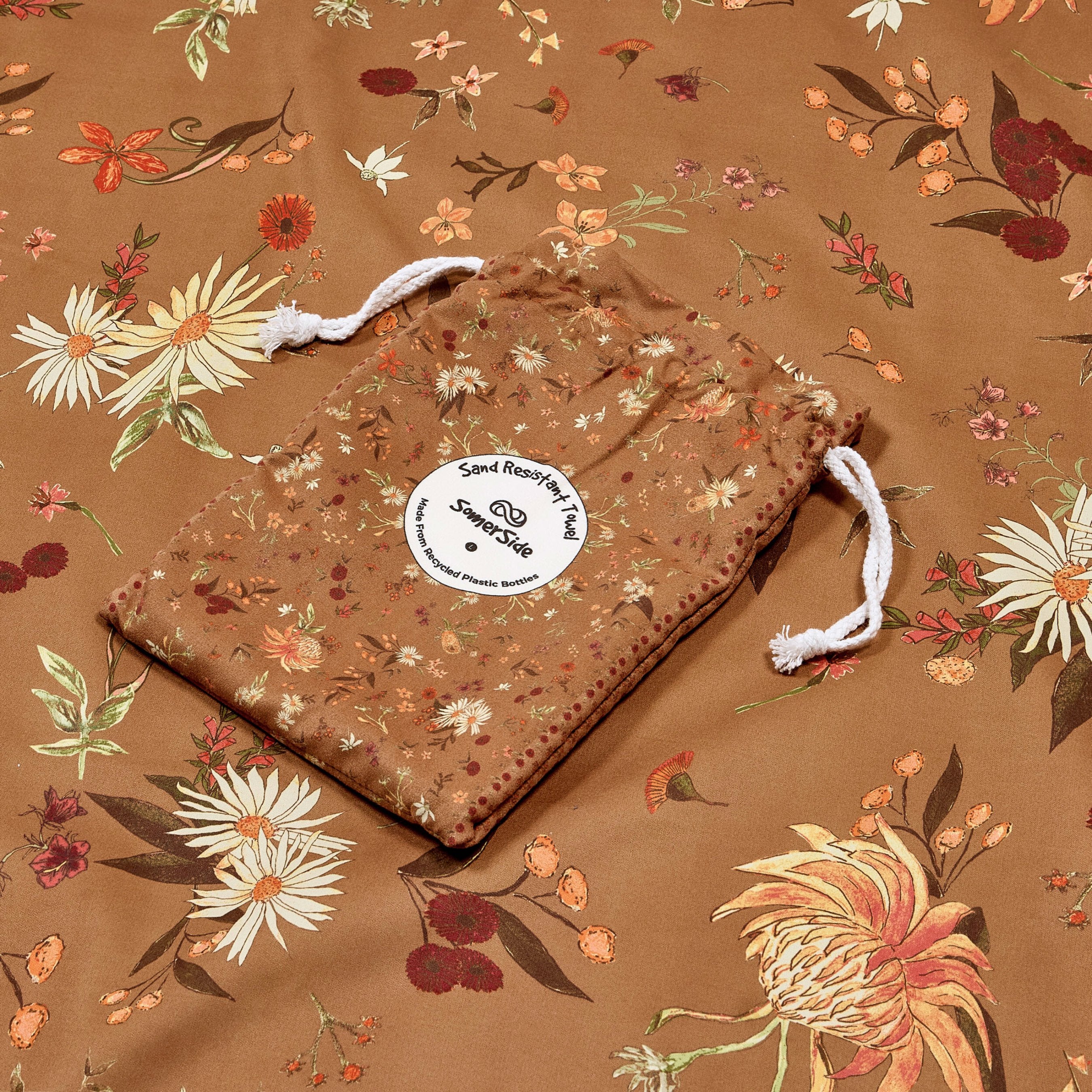 Floral-patterned drawstring bag on a matching floral wildflower towel