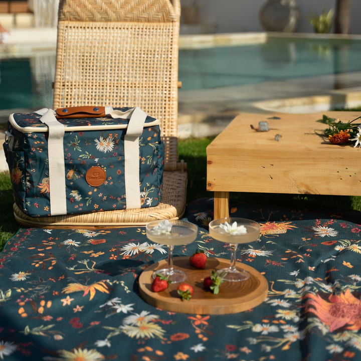 Floral-patterned cooler bag poolside, picnic setup