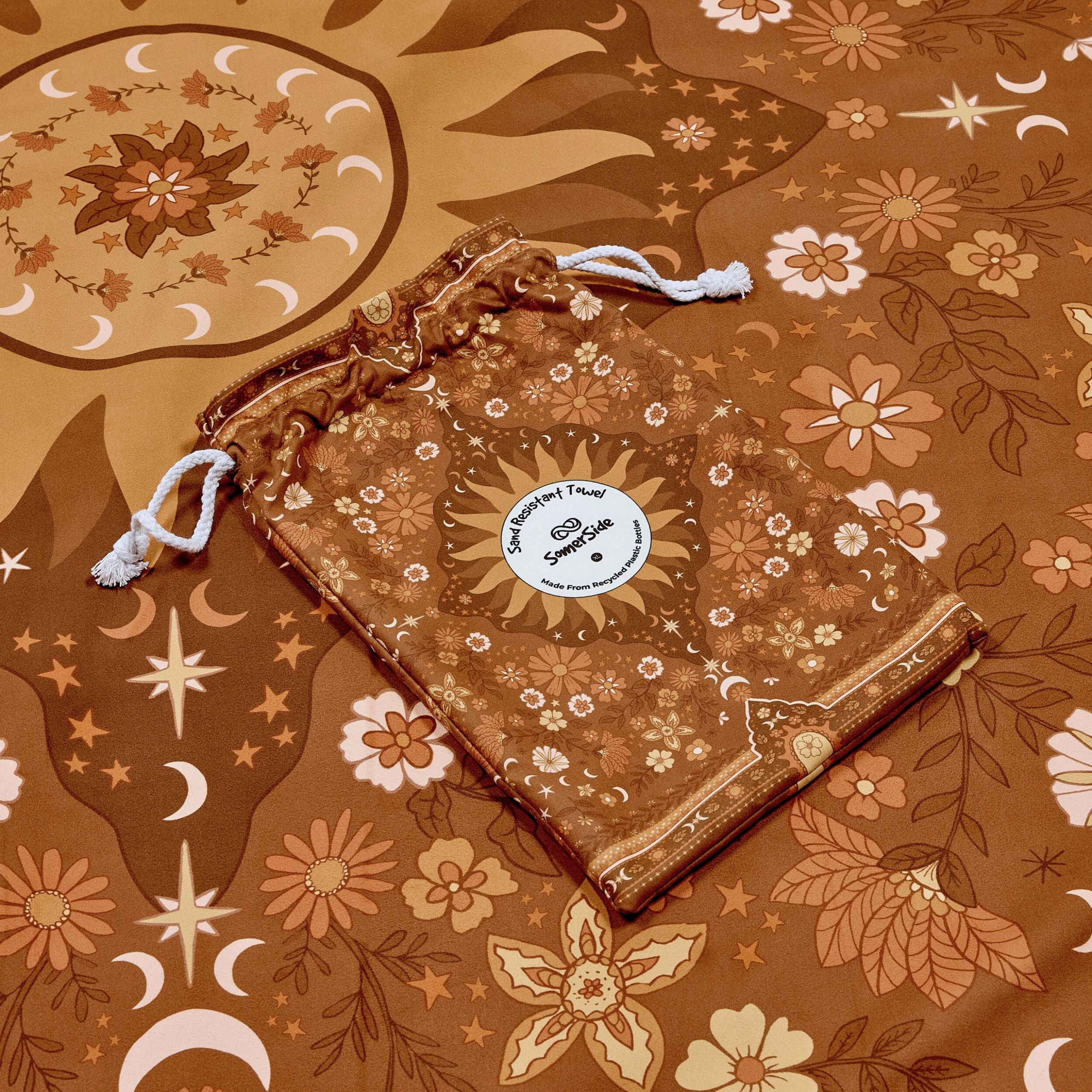 Drawstring bag with floral pattern on a matching boho brown towel