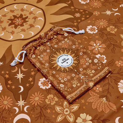 Drawstring bag with floral pattern on a matching boho brown towel