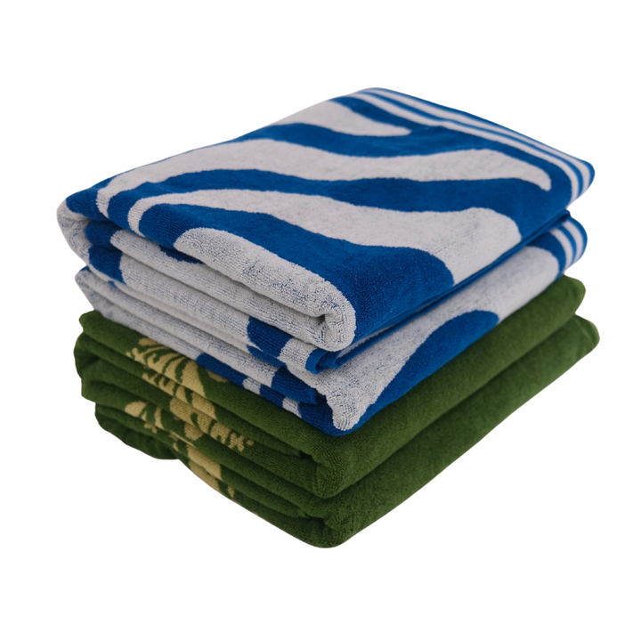 Stack of folded towels in blue, gray, and green on a white background