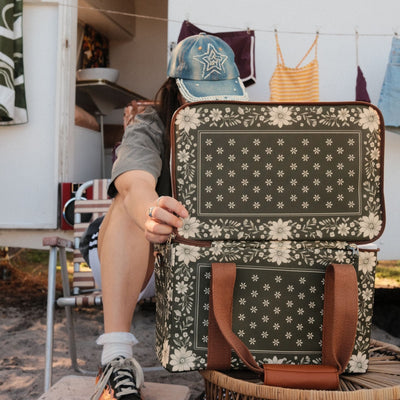 Eden insulated cooler bag, olive green floral bandana print, being opened by a caravan