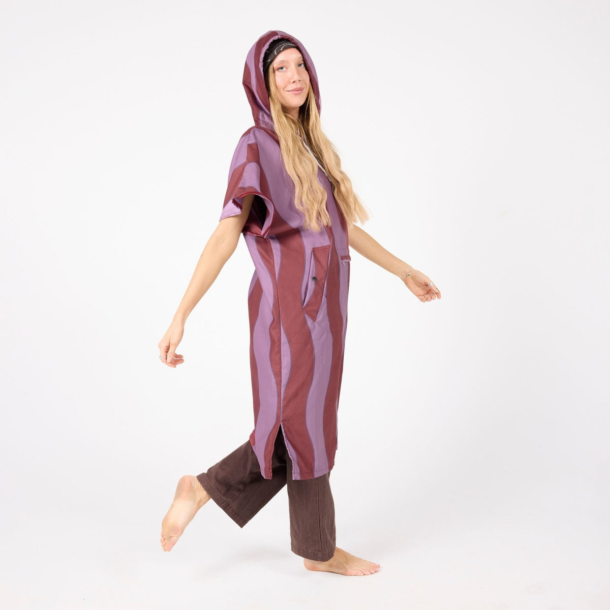 Jagger Shiraz adult hooded towel poncho, burgundy and mauve wavy stripe, on model walking