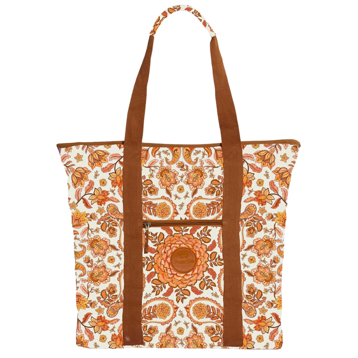 Floral patterned tote bag with brown handles on a white background, marigold centerpiece