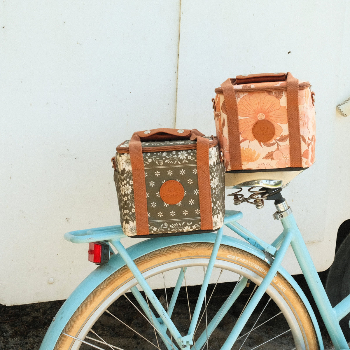 Eden and Summer Muse mini insulated cooler bags on the back of a bike