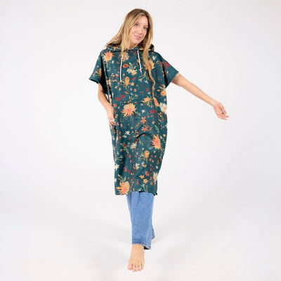Native Botanical adult hooded towel poncho, dark green Australian wildflower print, full length on model