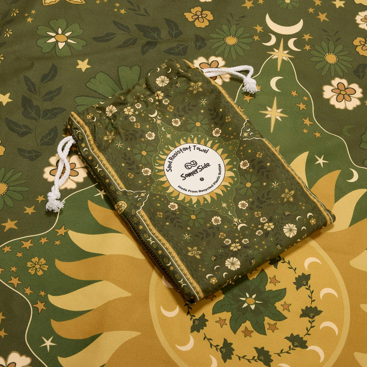 Green drawstring bag with celestial design on a matching towel - sun in bloom 
