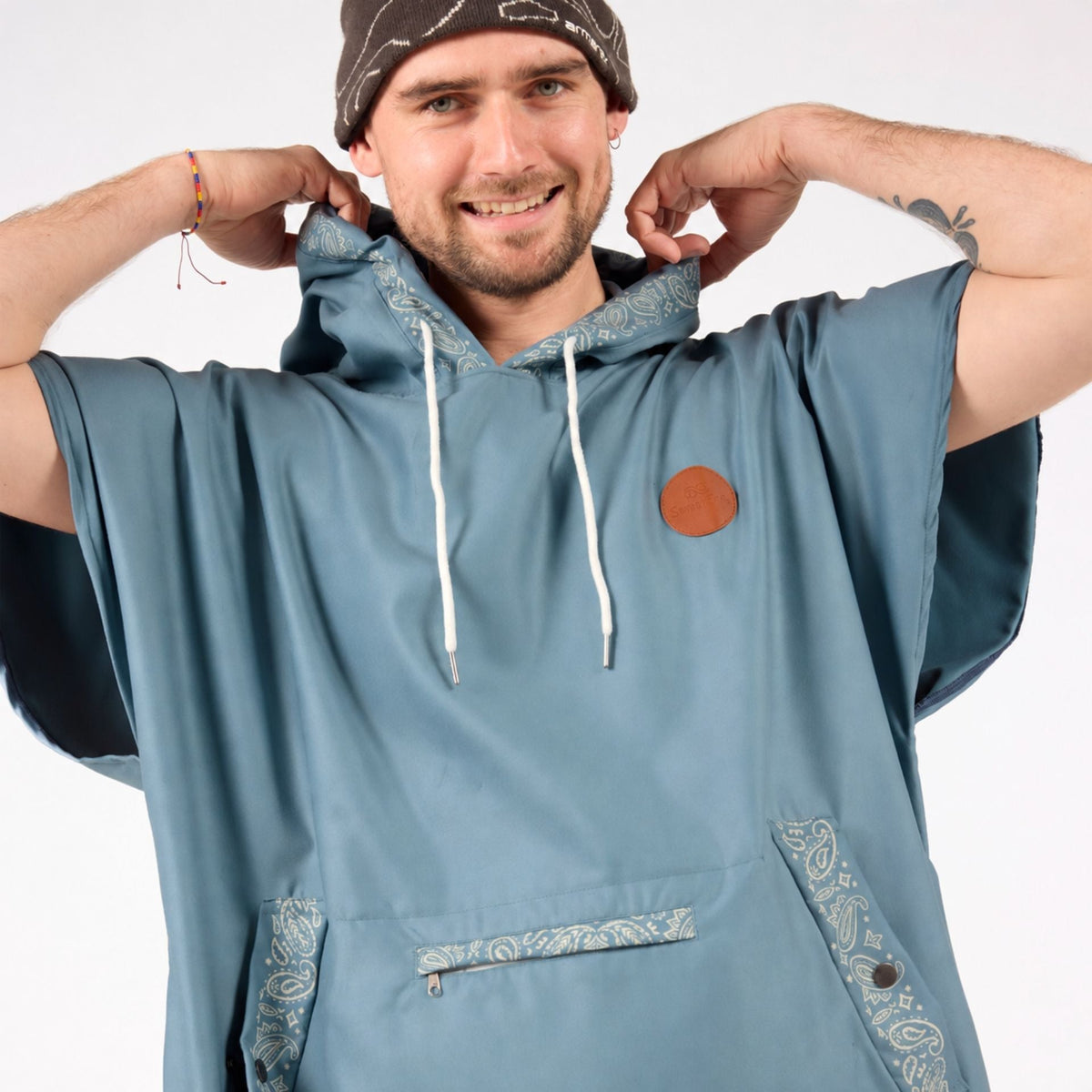 Venice adult hooded towel poncho, dusty blue paisley bandana print, on model with hood